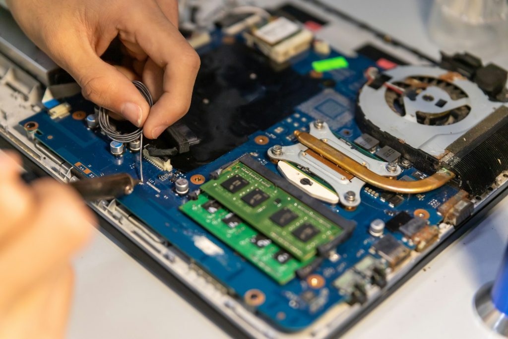 Computer repair technician repairing a laptop