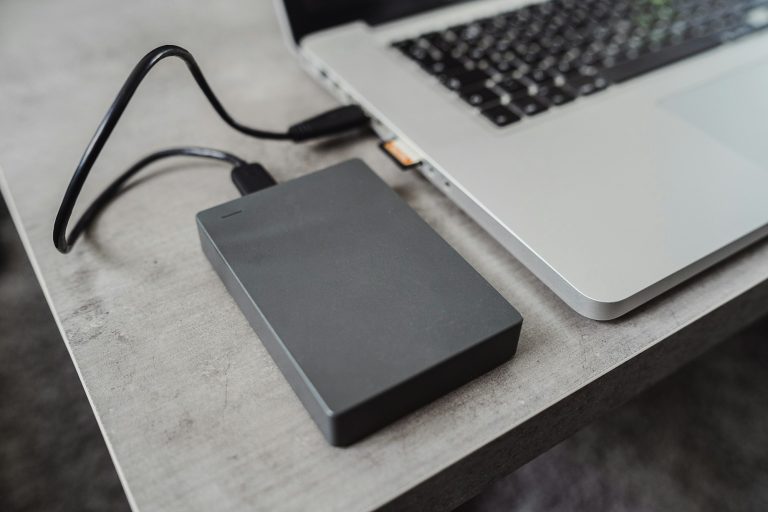 External hard disk drive connected to a modern laptop via USB